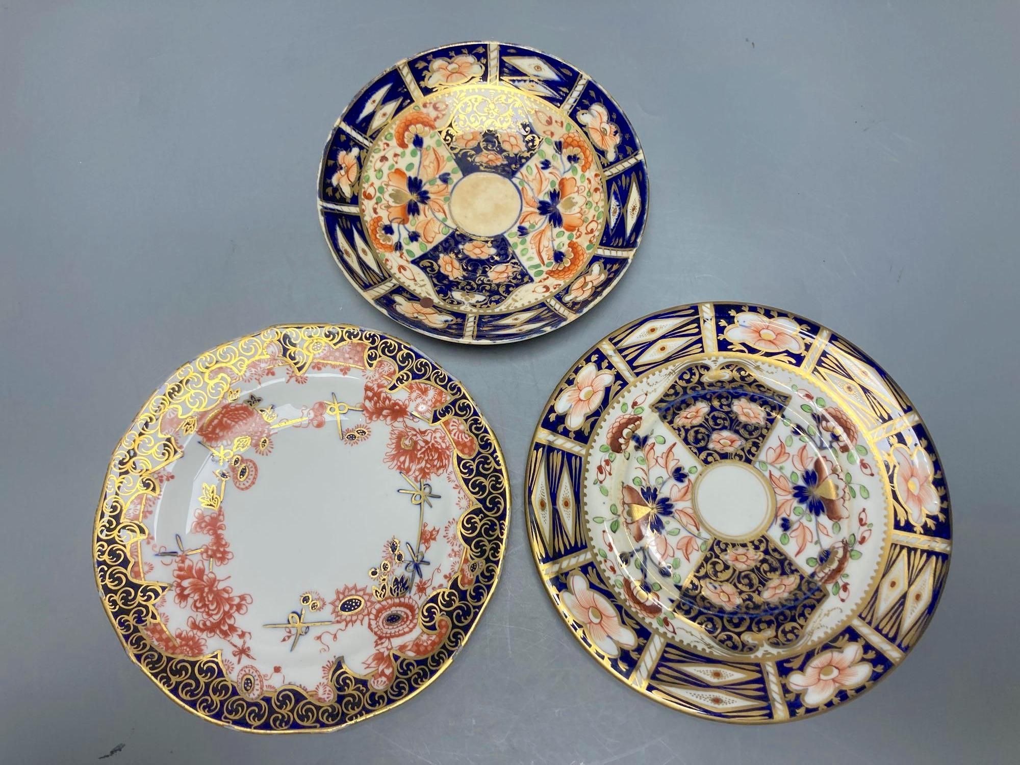 Two Royal Crown Derby Imari pattern plates, three Crown Derby plates or saucers, a Royal Crown Derby cup and two saucers and two Red Av